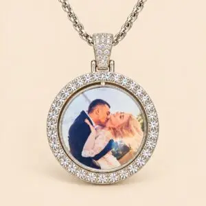 An elegant round pendant features a silver-tone alloy frame decorated with sparkling rhinestone accents