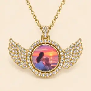 Gold-tone elegant pendant features sparkling angel wings and a rotating centre that holds two personalized photos