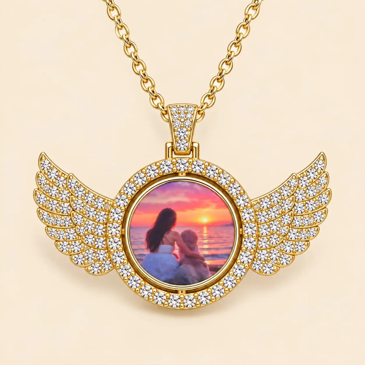 Gold-tone elegant pendant features sparkling angel wings and a rotating centre that holds two personalized photos
