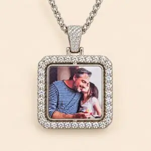 An elegant square pendant features a silver-tone alloy frame decorated with sparkling rhinestone accents