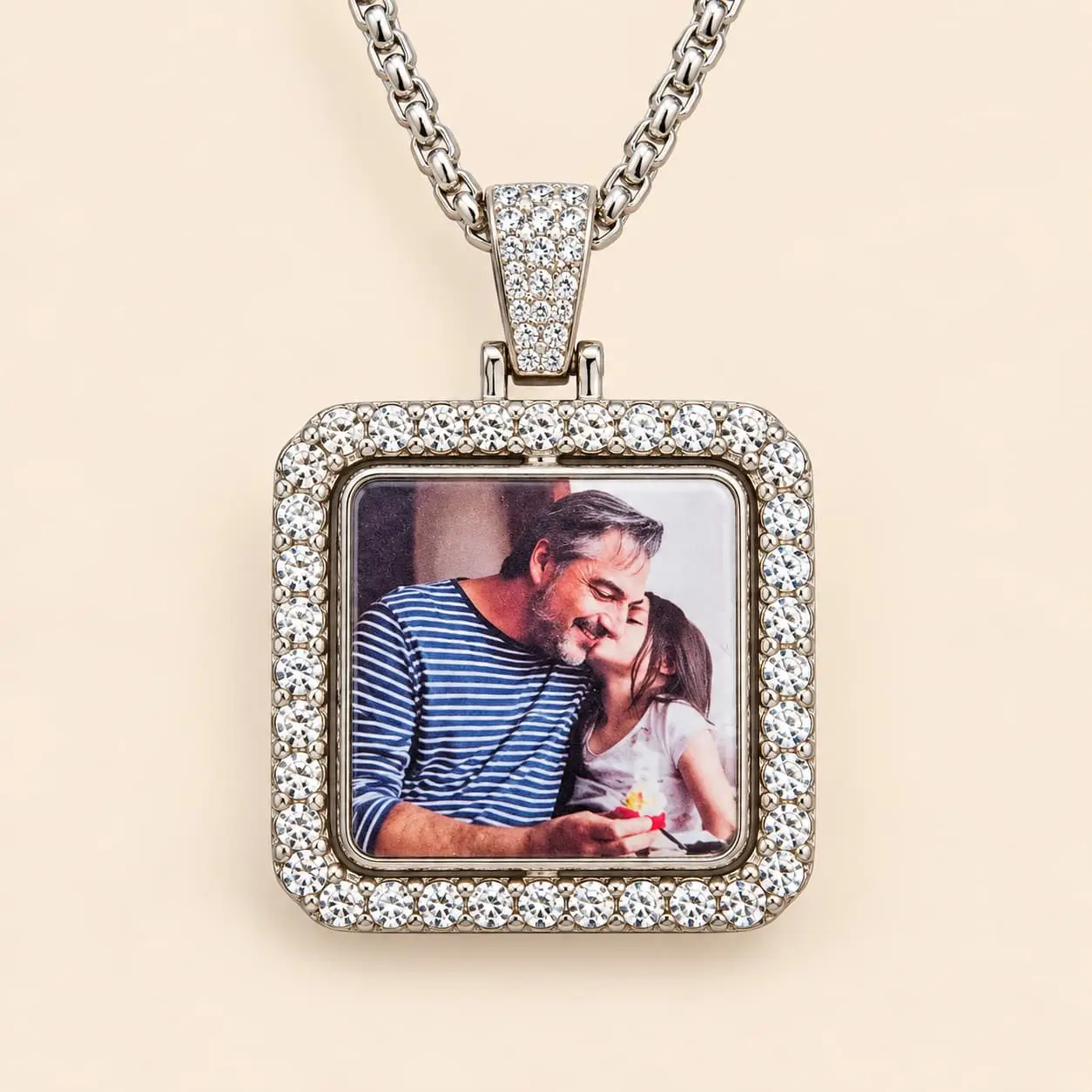 An elegant square pendant features a silver-tone alloy frame decorated with sparkling rhinestone accents