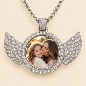 An elegant pendant features sparkling angel wings and a rotating centre that holds two personalized photos
